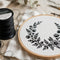 Stocking Stuffers: black embroidery thread and hoop with floral design for creative holiday gifts.
